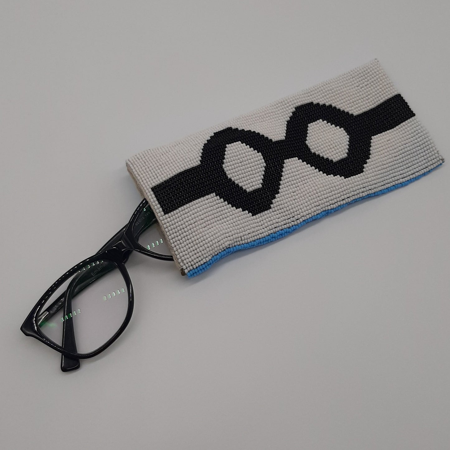 Glass bead eyeglass case black specs on white ground