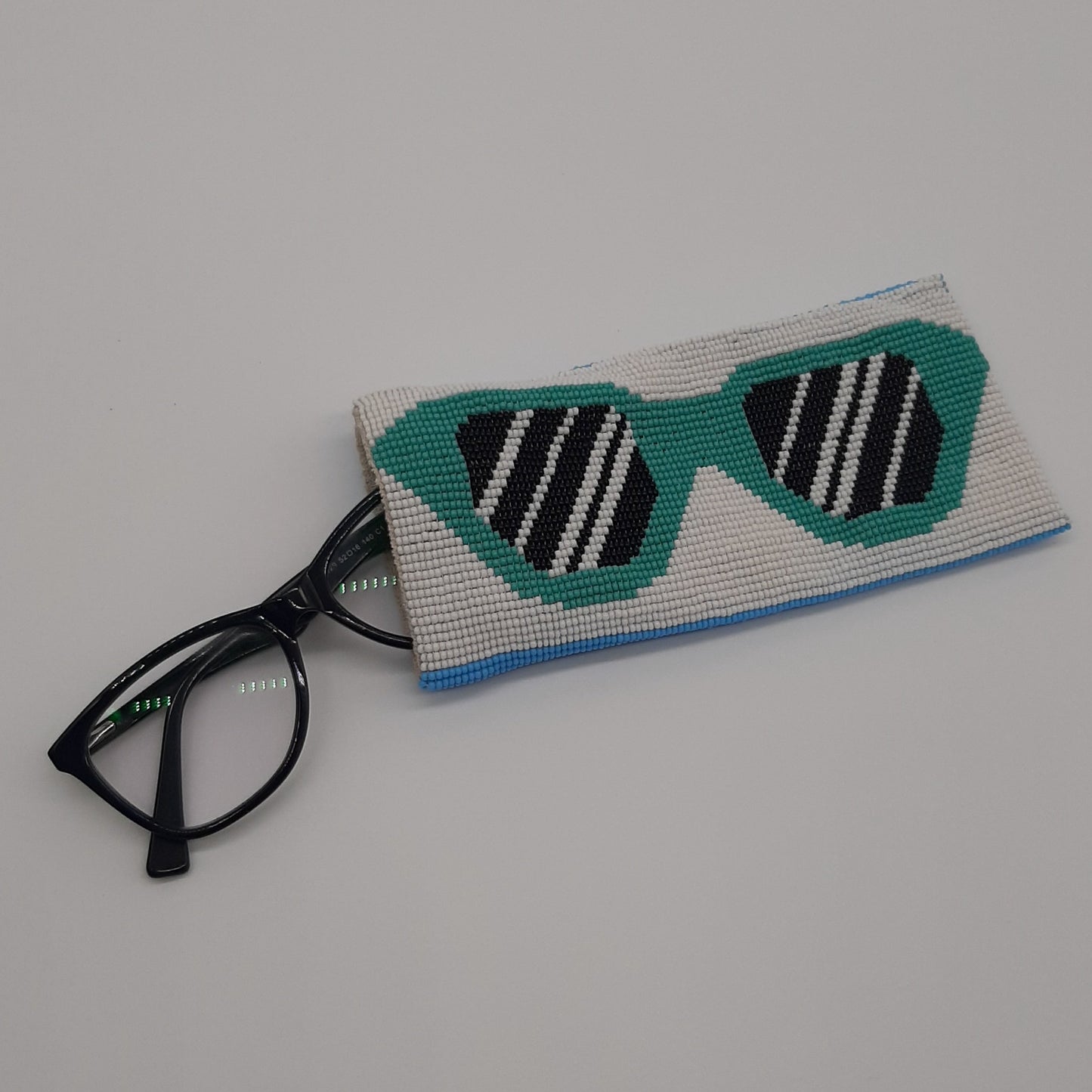 Glass bead eyeglass case turquoise specs on white ground